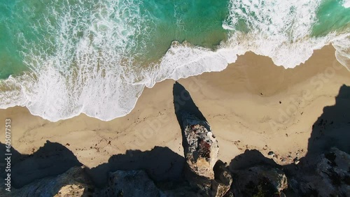 Aerial cinematic drone Big Sur California waves crashing Highway 1 coastline Rock Creek Bixby Creek Bridge vista viewpoint aqua ocean white sand beach at noon looking down motion