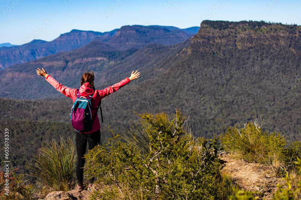 A backpacker girl enjoys the view from the top of Mount Mitchell after a successful hike, Main Range National Park, Gold, Coast, Queensland, Australia