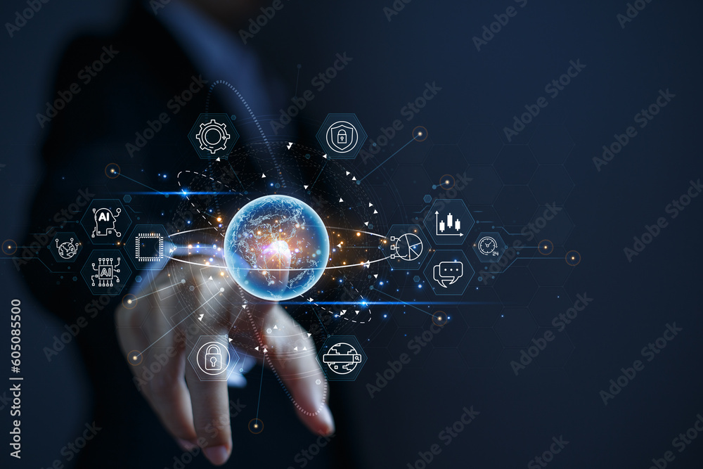Businessman pointing at a virtual globe with business related icons around it. The concept of connecting the business world by internet technology and artificial intelligence (AI). Businessman pointing at a virtual globe with business related icons around it. The concept of connecting the business world by internet technology and artificial intelligence (AI).