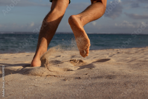 close-up. feet in the sand. run