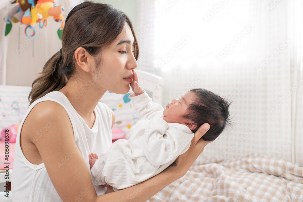 happy loving family. mother playing with her baby hugging in the bedroom , portrait of asian mother playing with newborn baby, health care family love together. asian girl lifestyle.. happy loving family. mother playing with her baby hugging in the bedroom , portrait of asian mother playing with newborn baby, health care family love together. asian girl lifestyle..