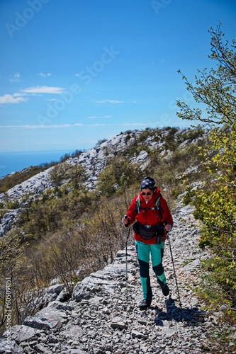 Senior woman hiking in karst landscape in Croatia