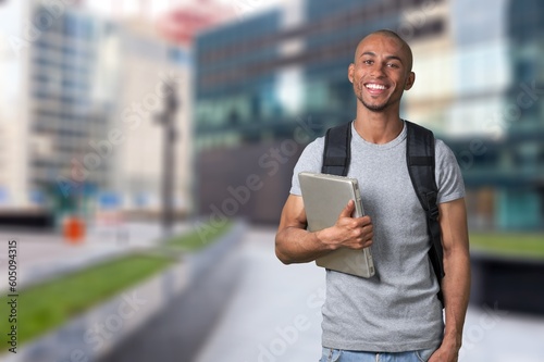 Happy young student with laptop computer