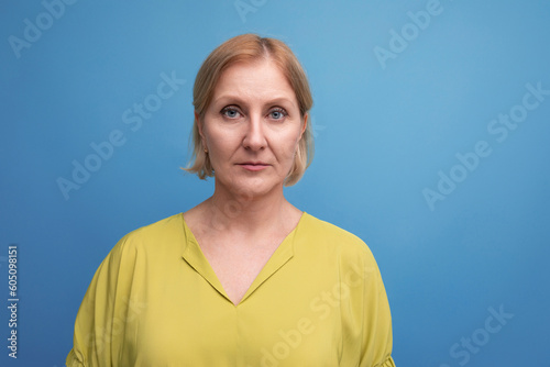 portrait of serious healthy middle aged blond woman with grimace