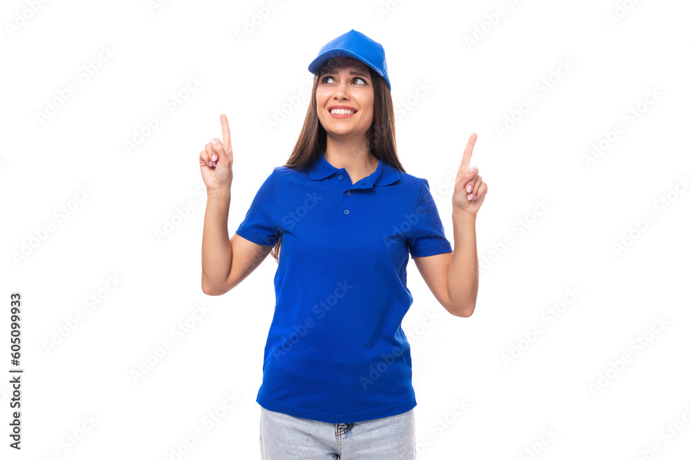 young caucasian brunette advertiser woman in blank blue t-shirt and cap showing thumbs up young caucasian brunette advertiser woman in blank blue t-shirt and cap showing thumbs up