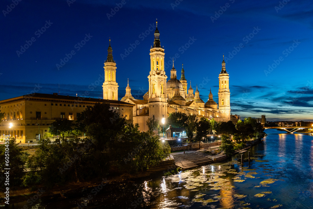 Zaragoza, Spain - May 01, 2023: ebro river, in front of the Basilica del Pilar, with very low water level due to drought and climate change in Zaragoza, Spain