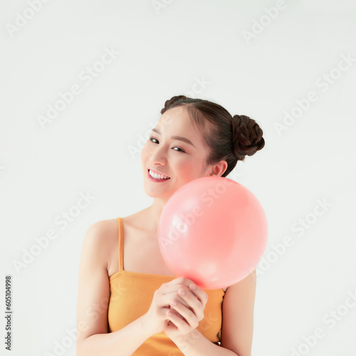 Cute portrait of young Asian woman in tank-top on white background © makistock
