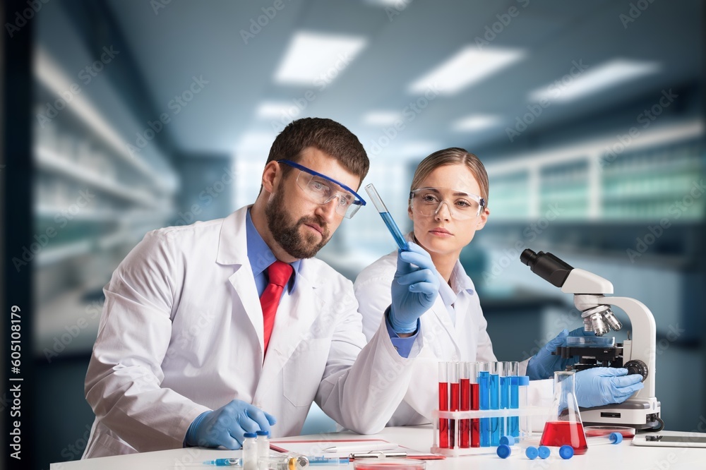 Young researcher with samples and microscope in lab Young researcher with samples and microscope in lab