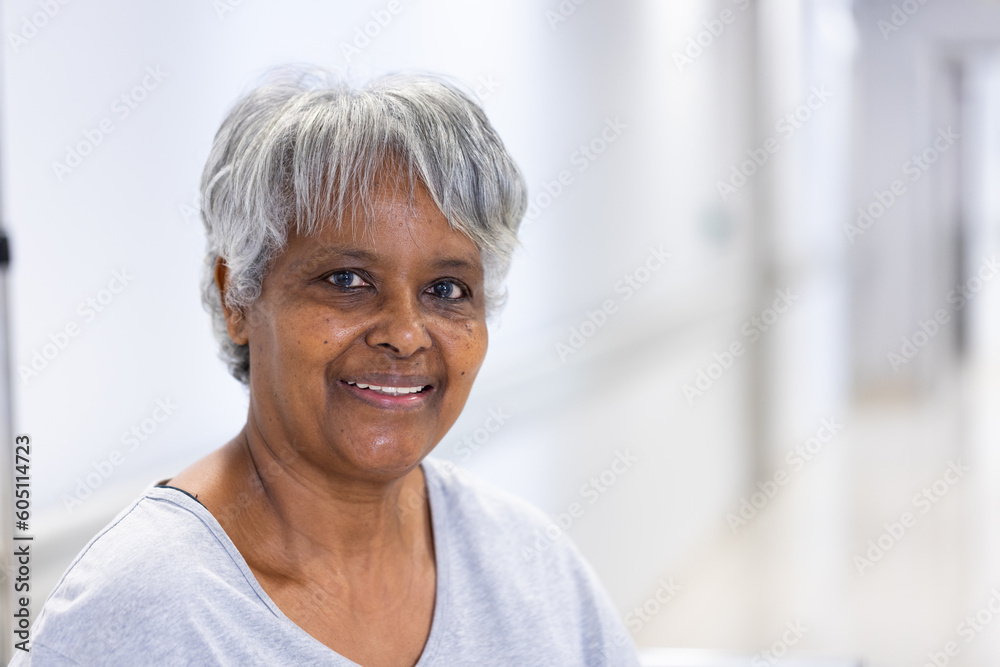 Unaltered portrait of happy senior biracial female patient smiling in hospital, with copy space Unaltered portrait of happy senior biracial female patient smiling in hospital, with copy space