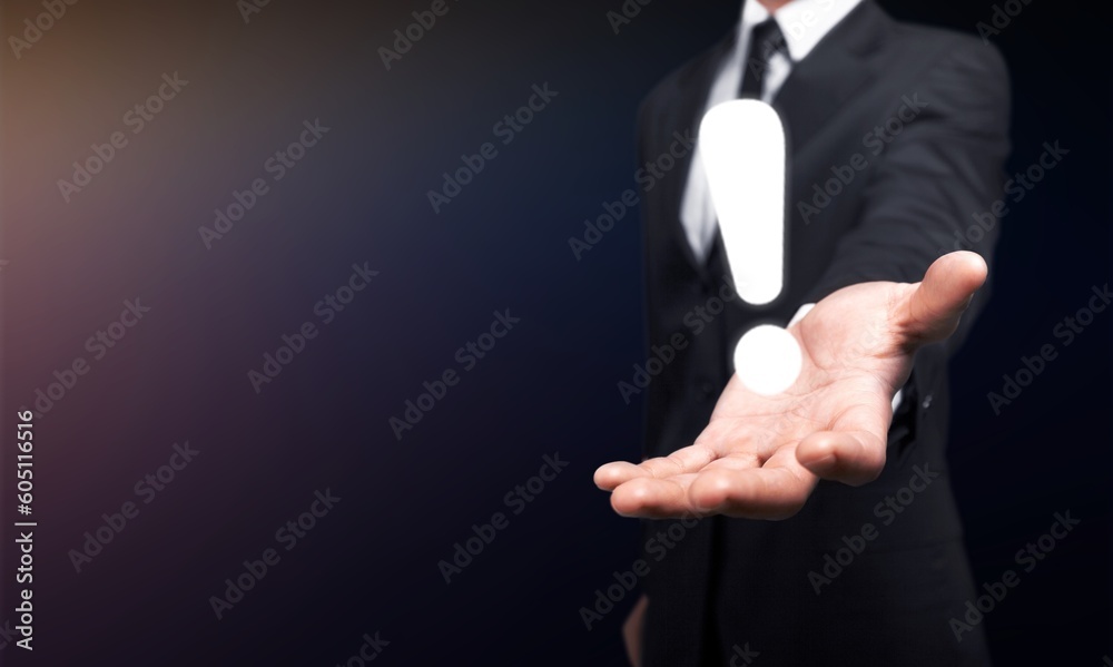 Male business worker hand with exclamation mark