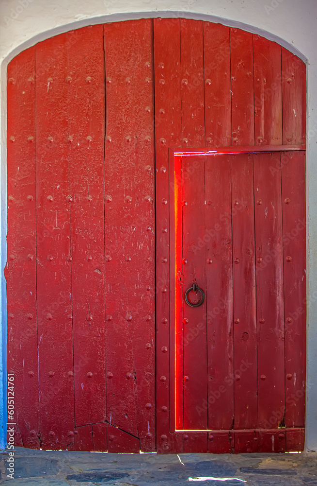 Old shabby ajar wooden door in the wall of the house Old shabby ajar wooden door in the wall of the house