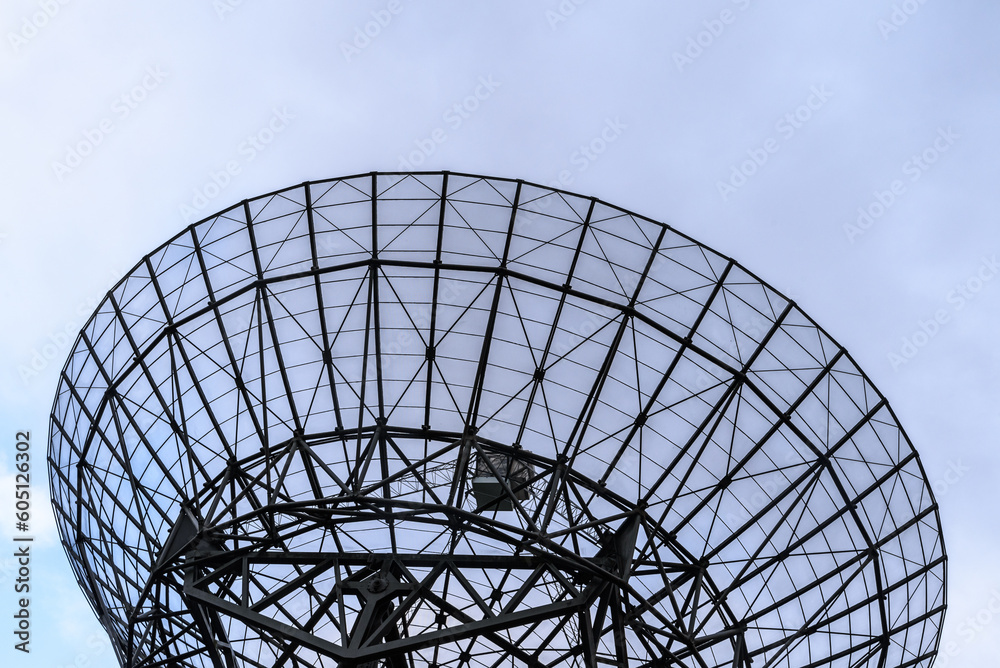 Close up of a radio satellite against a blue sky