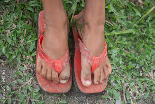 A boy is sitting with two feet on the ground