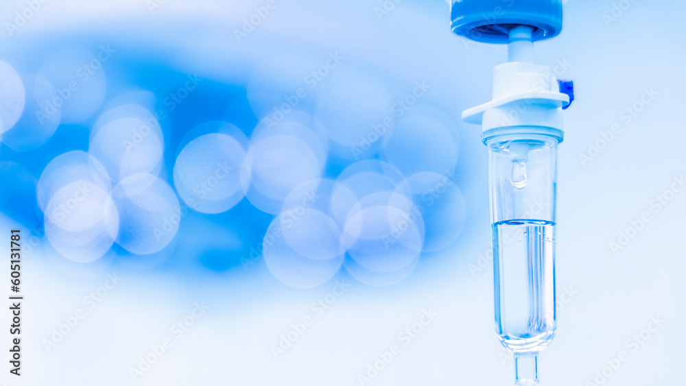 Blue tone of syringe pump with blurred background.Intravenous fluid used in the operating room while doctor did surgery.Surgical lamp in background.Medical concept.Emergency and shock patient. Blue tone of syringe pump with blurred background.Intravenous fluid used in the operating room while doctor did surgery.Surgical lamp in background.Medical concept.Emergency and shock patient.