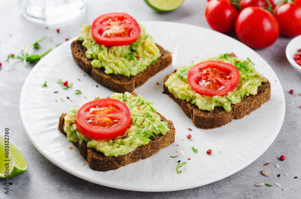 Avocado Toasts with Tomato, Healthy Snack or Breakfast on Bright Background Avocado Toasts with Tomato, Healthy Snack or Breakfast on Bright Background