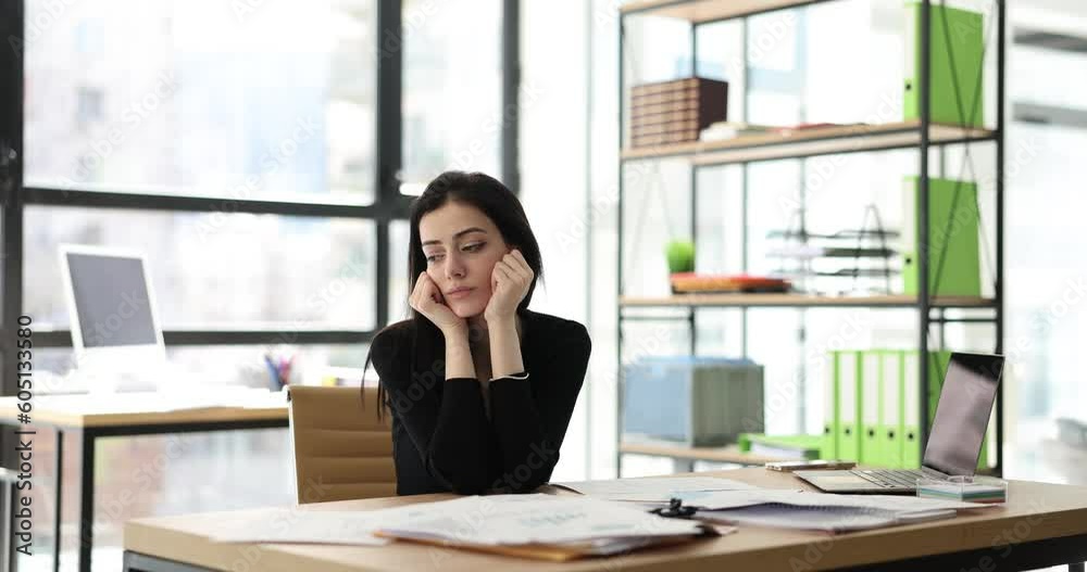 Business woman in office is serious about work stressed and worried about not completing tasks on time. Work fatigue and burnout Business woman in office is serious about work stressed and worried about not completing tasks on time. Work fatigue and burnout