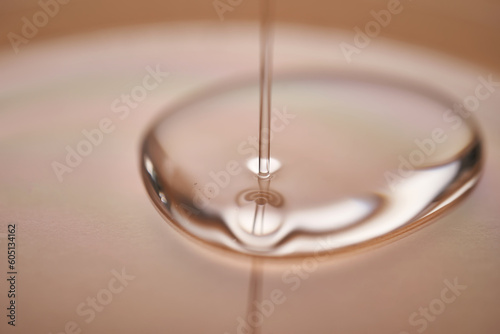 A juicy drop of gel on a beige background.
