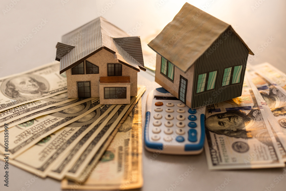 Real Estate Concept - Miniature Model House with Calculator Real Estate Concept - Miniature Model House with Calculator