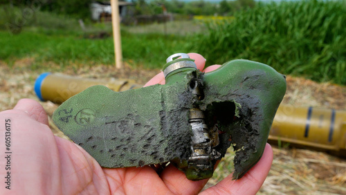 Photos A torn anti-personnel mine damaged by an explosion, a petal in his hand