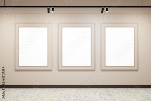 Bright beige gallery room interior with three blank white picture frames and concrete floor. Gallery  exhibition  advertising concept. Mockup  3D Rendering