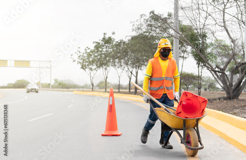 Latino worker performing highway clean-up: A dedicated effort for a cleaner environment.