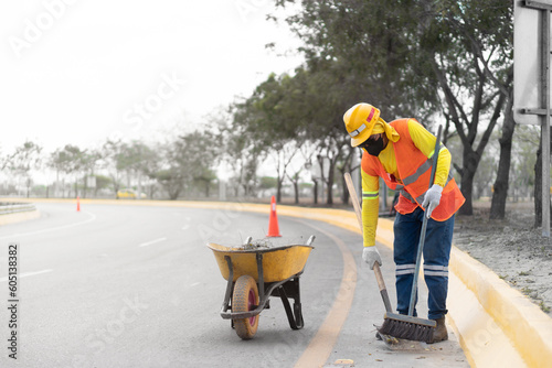 Latino freeway trash collection worker: Keeping the roads clean and safe.