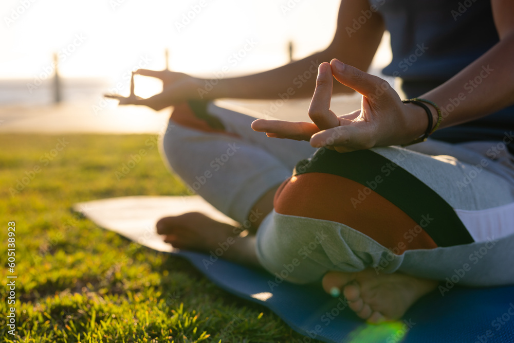 © Wavebreak Media - Low section of biracial man practicing yoga meditation on promenade by the sea at sundown © Wavebreak Media - Low section of biracial man practicing yoga meditation on promenade by the sea at sundown
