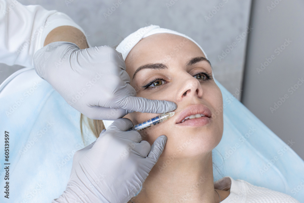 A cosmetologist in medical gloves fills women's wrinkles with hyaluronic acid A cosmetologist in medical gloves fills women's wrinkles with hyaluronic acid