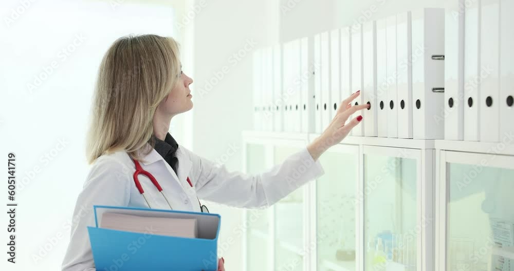 Doctor looking for folder with documents in office 4k movie slow motion. Paperwork organization in medicine concept Doctor looking for folder with documents in office 4k movie slow motion. Paperwork organization in medicine concept
