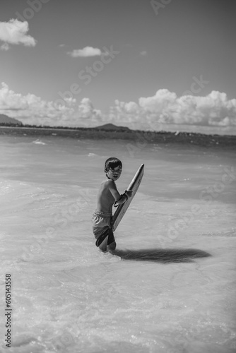 Multiracial Asian boy looking back towards the shoreline at Kail photo