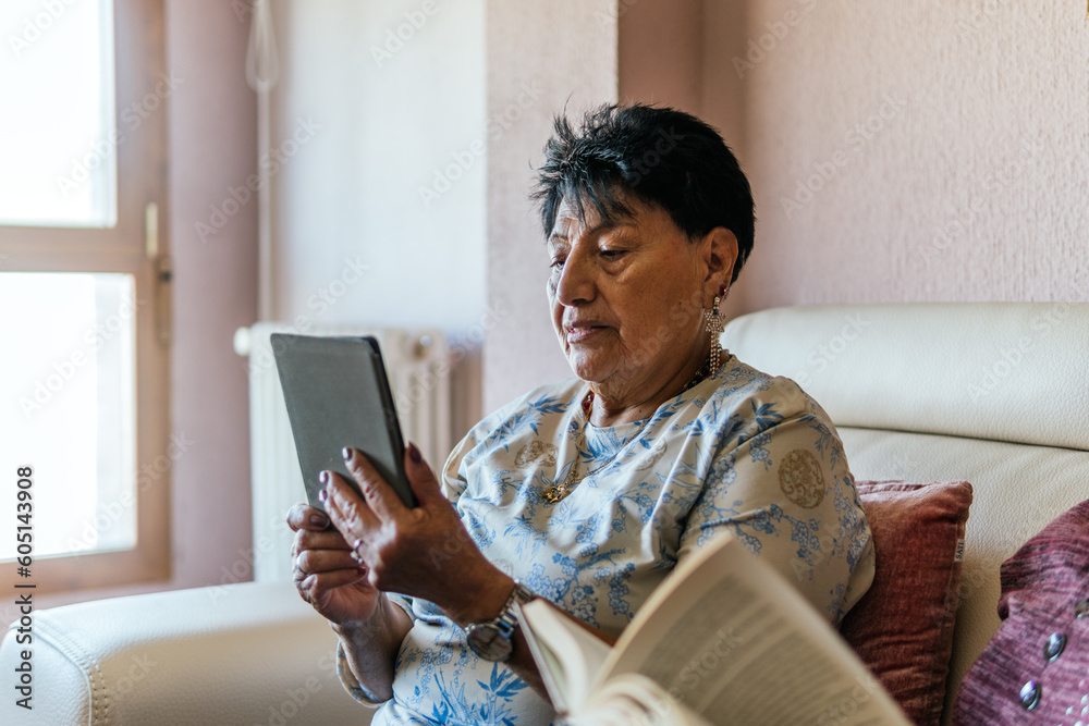 latin american woman reading with an electronic book