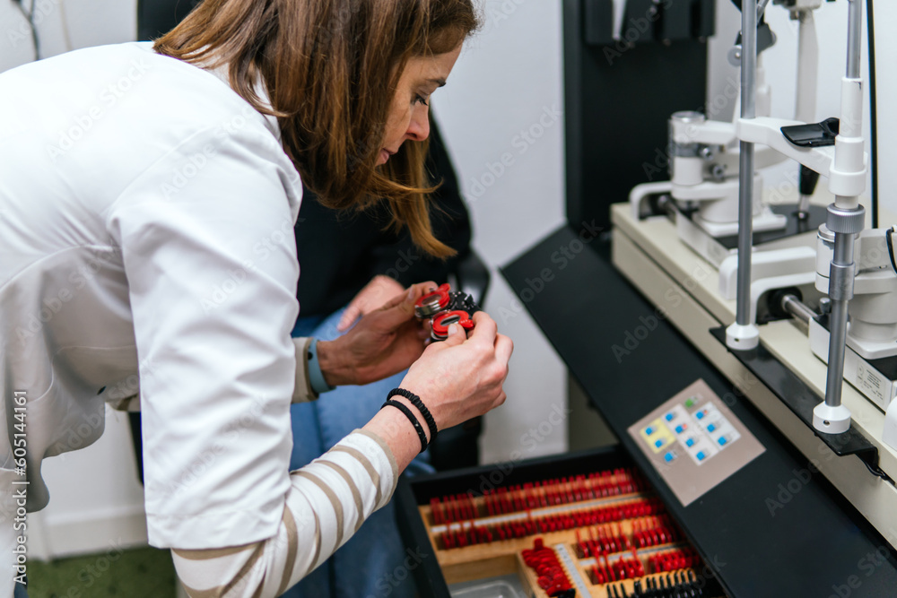 oculist measuring diotrics to a patient in an optician oculist measuring diotrics to a patient in an optician