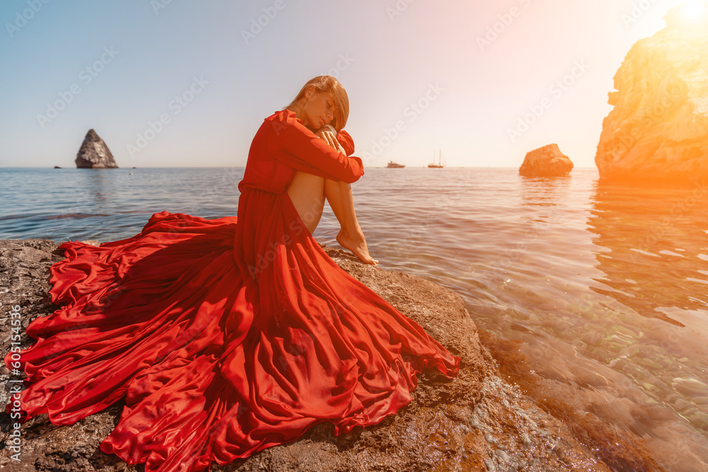 woman sea red dress. Beautiful sensual woman in a flying red dress and ...