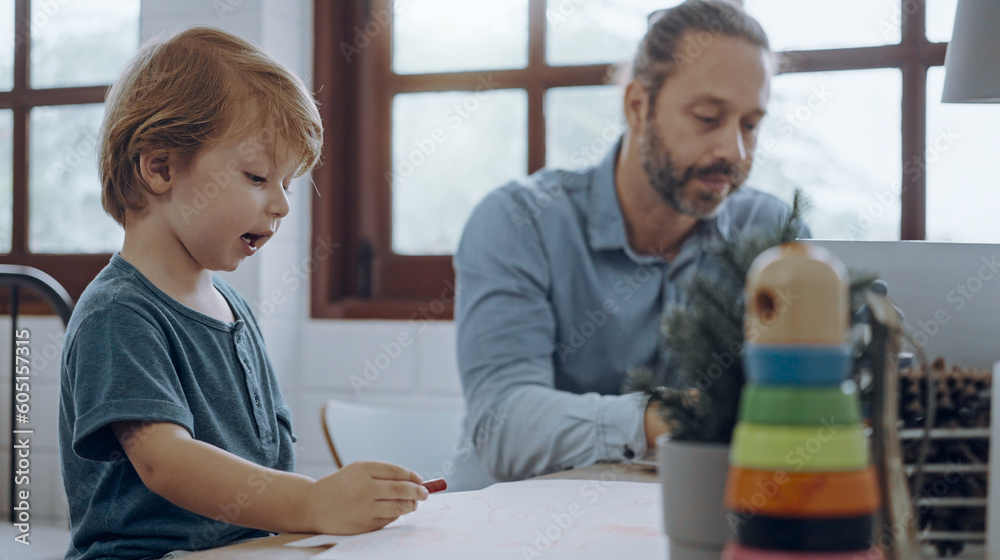 Obraz premium Father working from home office using laptop sit at table with cute little son playing nearly to disturb.