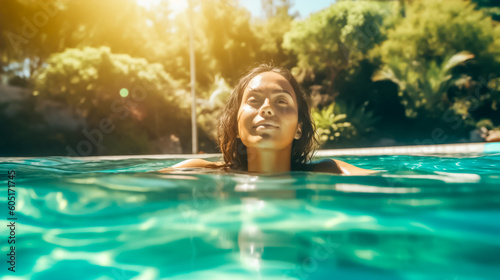 Beautiful young woman relaxing in a pool in the summer sun. Fashion or glamour photography of a model, close up with shallow field of view. Illustrative Generative AI. Not a real person. © henjon