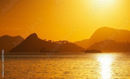 Rio de Janeiro sunrise next to Sugar Loaf landmark mountains. Beautiful photo with the landscape of Rio de Janeiro city with its amazing beach bay area. Travel to Brazil.