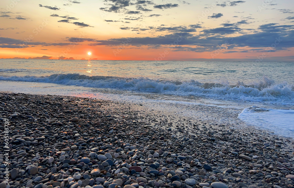 Sea beach shore with waves in ocean. Pebble stone beach on sunrise ...