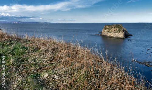 Cliffs and bay at Dunnet Head. Scotland. North coast. North Sea. Orkney Islands in the back.