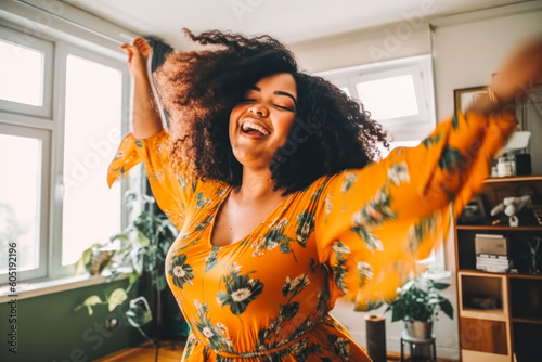 Tableau sur toile Positive plus size black woman dancing at home