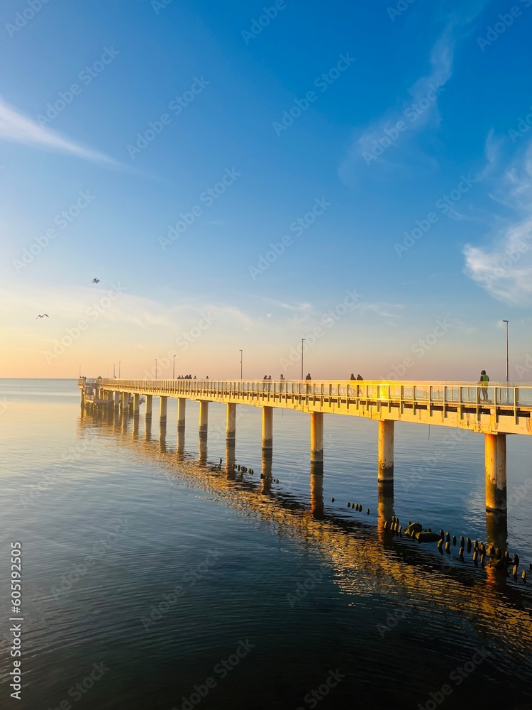 Old big pier at the sea, sunset seascape sky 