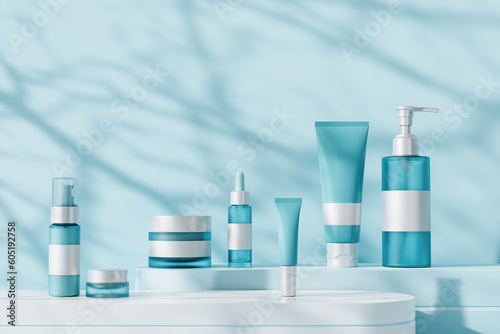 Set of unbranded cosmetic products on geometric platforms. Cosmetics for skin care. Shadows on blue background.
