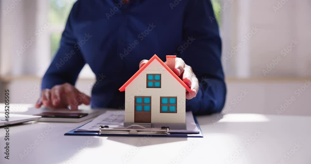 Person Hand Calculating A Real Estate Property Tax Person Hand Calculating A Real Estate Property Tax
