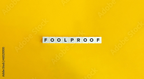Foolproof Word on Block Letter Tiles on Yellow Background. Minimal Aesthetic.