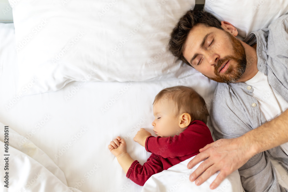 Father and little baby sleeping together in bed. Father and little baby sleeping together in bed.