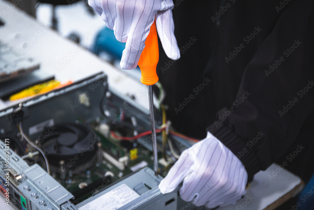 A technician is repairing a computer by replacing it. power supply computer A technician is repairing a computer by replacing it. power supply computer