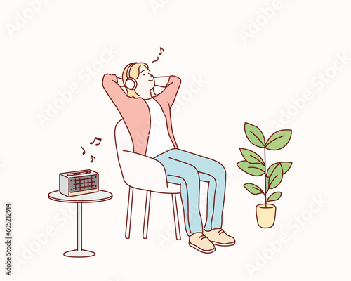 woman listening to music in wireless headphones sitting in armchair. Hand drawn style vector design illustrations.