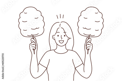 Smiling woman holding cotton candy 