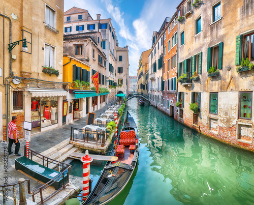 Fototapete Gorgeous cityscape of Venice with narrow canals, boats and gondolas and bridges