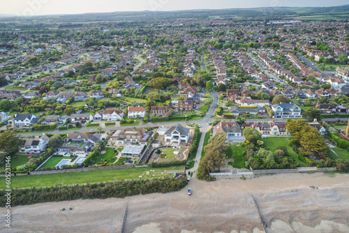 Aerial view over the West Sussex village of East Preston on the Southern Coast of England from the beach towards sea lane.
