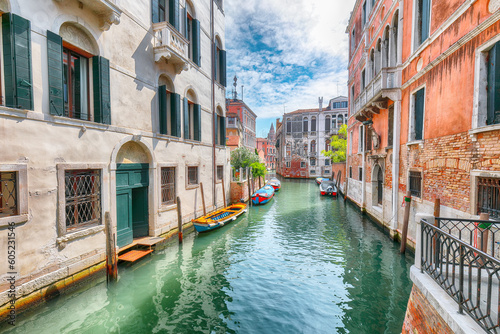 Fabulous cityscape of Venice with narrow canals, boats and gondolas and bridges with traditional buildings © pilat666